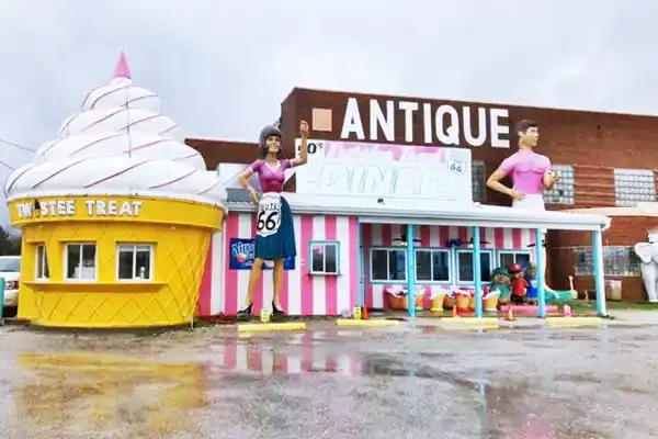 Large fiberglass sculptures, ice cream cone by red brick building