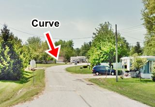 original Lincoln St. IL-4 in Auburn narrow road, in an urban setting, curves right