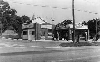 Barnsdall station Lockport c.1930 1930s black and white view gas station, flat canopy, car, signage on State St. Lockport IL