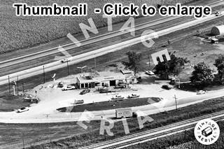 1966 aerial Benedict gas station US66 black and white 1966 aerial photo; box shaped gas station, cars, pumps, behind is 4-lane US66, in front another older alignment of US66