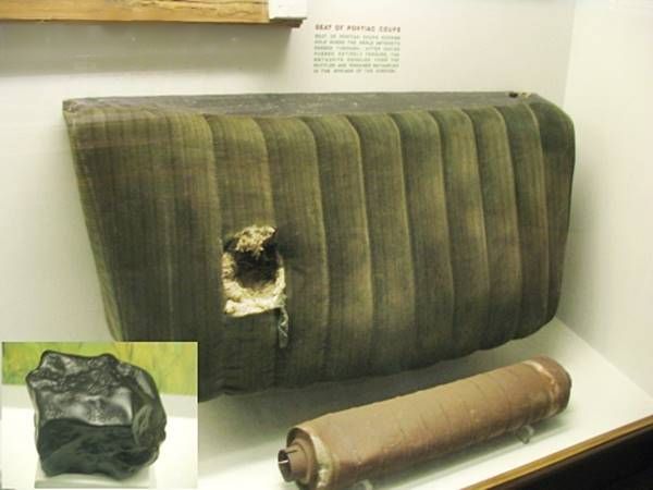 black smooth meteorite and a green upholstered chair and muffler