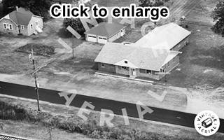 Roadhouse 1980, Route 66 Braceville black and white 1980 aerial view of a building and parking area with US 66 running by it, woods