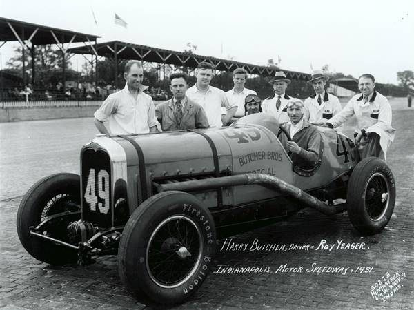 black and white 1931, racing car, 2 seater, men around it BUTCHER BROS. SPECIAL written on cockpit