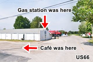 looking along a street, trees, parking lot and building to the left are the former cafe