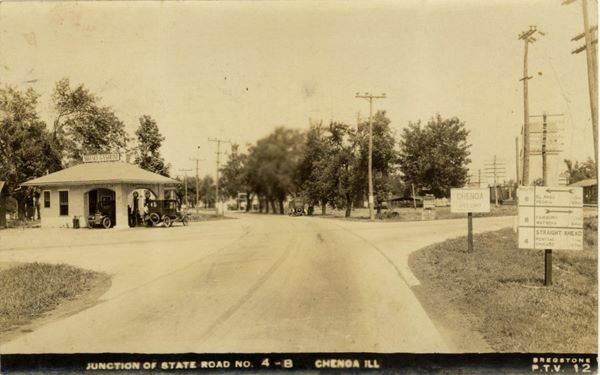 Route 4 and 8 junction Chenoa, 1922 black and white 1922 crossroads IL-4 and 8, gas station on the left corner with 2 cars under canopy, car driving away on rte 4