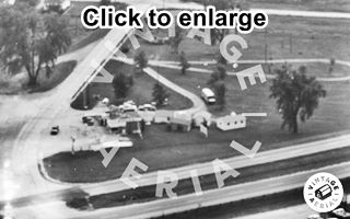 Sinclair Gas Station Chenoa US 66, 1966 Black and white, 1966, aerial view icebox gas Sinclair station at an intersection. Cabins behind it (right) Old US 66 on the left. Cars, highway, trees