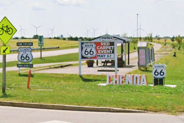 color, signs, shields of US66 and a monument spelling CHENOA with its US66 shield. Fields beyond