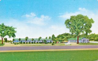 Chenoa Motel postcard color 1957 linnen postcard single story gable roof motel, trees and highway in front