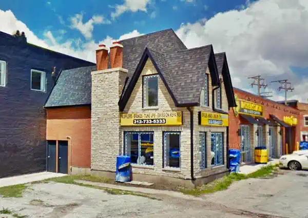 steep gable roofed, stone cottage building, former gas station