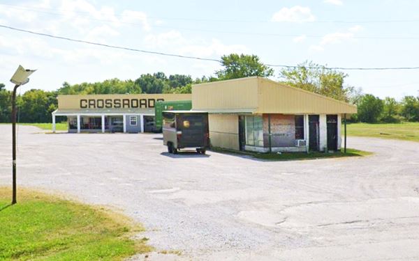 Crossroads Restaurant and old Amoco US66 Mt. Olive vacant boarded Amoco station with modified roof, and beyond it a old Restaurant with the word CROSSROADS on its yellow facades