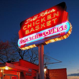 Dell Rheas Chicken Basket Neon sign glowing at night