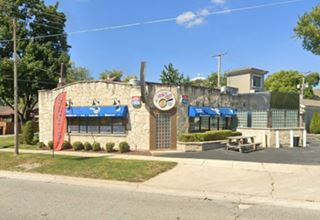 limestone block building, glass brick wall, single story seen from US66