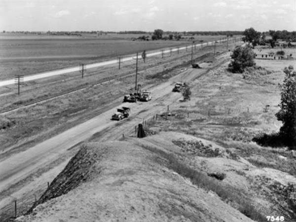 black and white, old US66 seen from a pile of slag, further away is the new alignment. Trees, fields