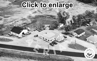 Grays gas station 1980, Route 66 Braceville black and white 1980 aerial view of a building and parking area a gas station with US 66 running by it houses, shed and woods