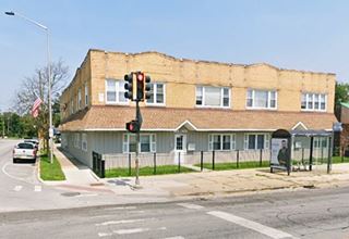 2 story yellow brick late 1800s former drugstore corner building