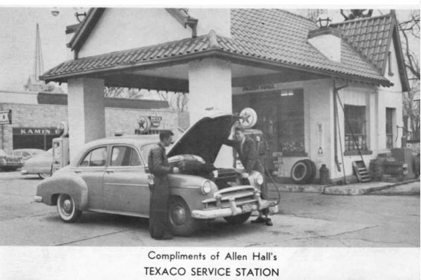 black and white, 1958, Texaco station tiled gable roof canopy over box columns, car, attendant, customer