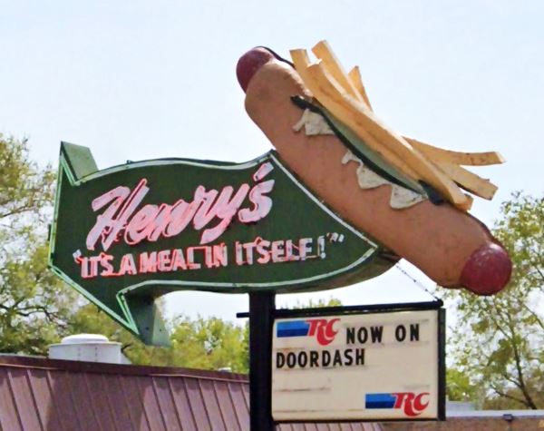 Henrys hot dog neon sign, US66 Cicero hot dog topped with mustard and french fries with a wavy green arrow stating "Henry’s - It's A Meal In Itself"</i>