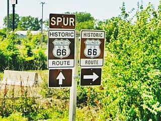 brown Historic US 66 signs by shoulder