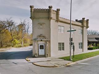 2 story stone building castle-like on a sharp corner
