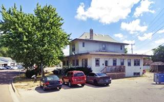 color, a 2 story hip roof building with trees, street on the left