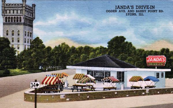 color linnen postcard, Hofmann tower to the right behind, and a corner drive-in with tables and sunshades over them