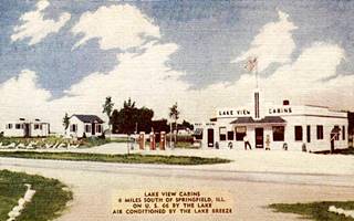 Bedini Lake View Cabins color linnen 1940s postcard, cabins and a gas station, US 66 runs across the image