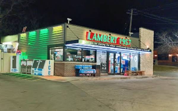 lit up convenience store LAMBERT 1957 written on it, night view