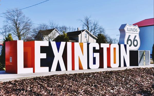 word LEXINGTON in white faced solid letters with colored sides, and US66 shield