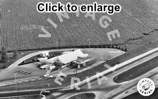 Lexington Stuckey’s 1966 Black and white, 1966, aerial view building of a Stuckey’s on the left, cars, pumps, drive. Route 66 to the right