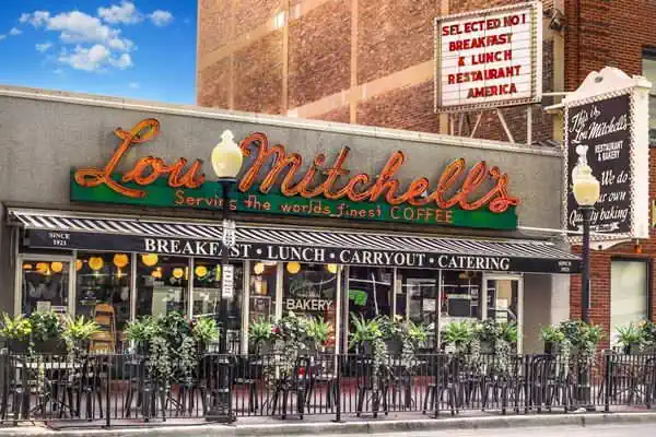 1 story flat roof restaurant red neon sign says LOU MITCHELLs