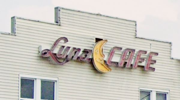 facade neon sign with words Luna Cafe and a smiling crescent moon between them;