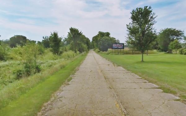 old narrow 2 lane road by a park (right) and railroad (left): Memory Lane in Lexington Route 66