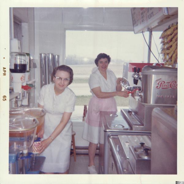 Arline Winterland and Verneil Siron in the Oasis Drive In, US66, 1965 Lexington color, Polaroid, two women with aprons in a Kitchen of a Drive In dated April 1968