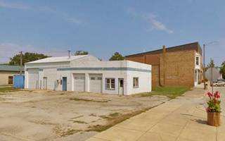 color, white block building a former gas station on a corner