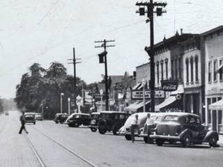 late 1930s view gas stations on State St. Lockport IL black and white c.1939, view along State St in Lockport: cars, people, stores, gas stations