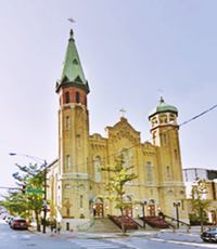 church, sandstone, tall steeple left, onion dome on right tower