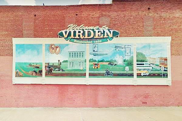 The second mural painted on a red brick wall, depicting the history of Virden