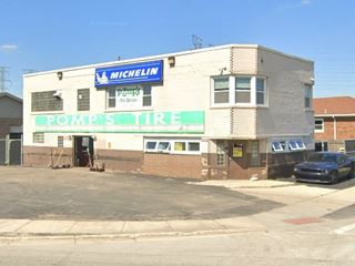 color, 2 story brick building on a corner, service bays to the left, a former garage