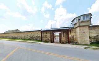 Tall walls, fenced in prison gate, movie location