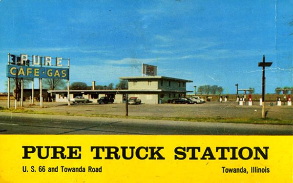 color postcard, 1960, cars barked by flat roof restaurant and office, PURE CAFE GAS sign to the left, pumps to the right.