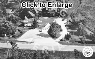 The Riviera and Route 66 Gardner, aerial view 1975 black and white 1975 aerial view of a building and parking area with US 66 running by it, woods