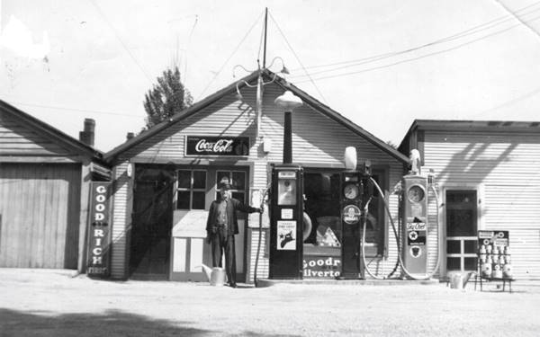 Roebuck Texaco station Lemont c.1920s black and white 1920s, man by 3 Texaco pumps, a gas station gable roof, no canopy, woodframe