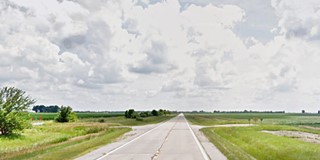 Route 66 strait and flat among farmland in Illinois prairies