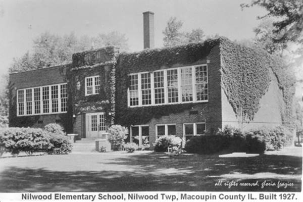 two-story, box shaped, red-brick walls covered with ivy: a school building in a 1940s black and white photo