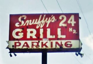 red neon sign white letters, rectangular. Snuffy’s