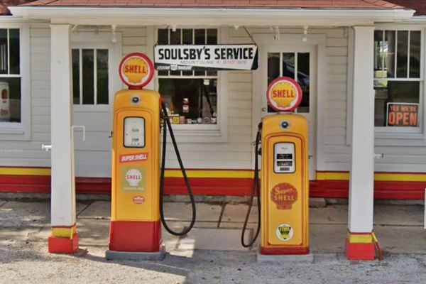 Soulsby’s Service Station gas pumps two old Shell gas pumps on an island under hipped roof canopy, office is behind them