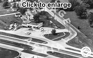 Standard Gas Station Chenoa US 66, 1966 Black and white, 1966, aerial view icebox gas Standard station at an intersection. 4-lane US 66 runs in front. Cars, trees