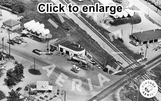 Standard Gas Station Chenoa US 66, 1968 Black and white, 1968, aerial view icebox gas Sinclair station in an urban setting, railroad behind it