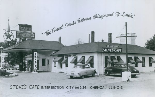 1941 view Steve’s Cafe and Texaco Route 66 Chenoa black and white 1941: hip roof building, a cafe, with signs saying STEVES CAFE, and Texaco pumps and signs under a hipped canopy. Church Steeple behind, cars