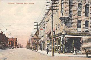 Stillman’s pharmacy, 1909, Joliet 2 story stone building on a corner, commercial street, horse on the right